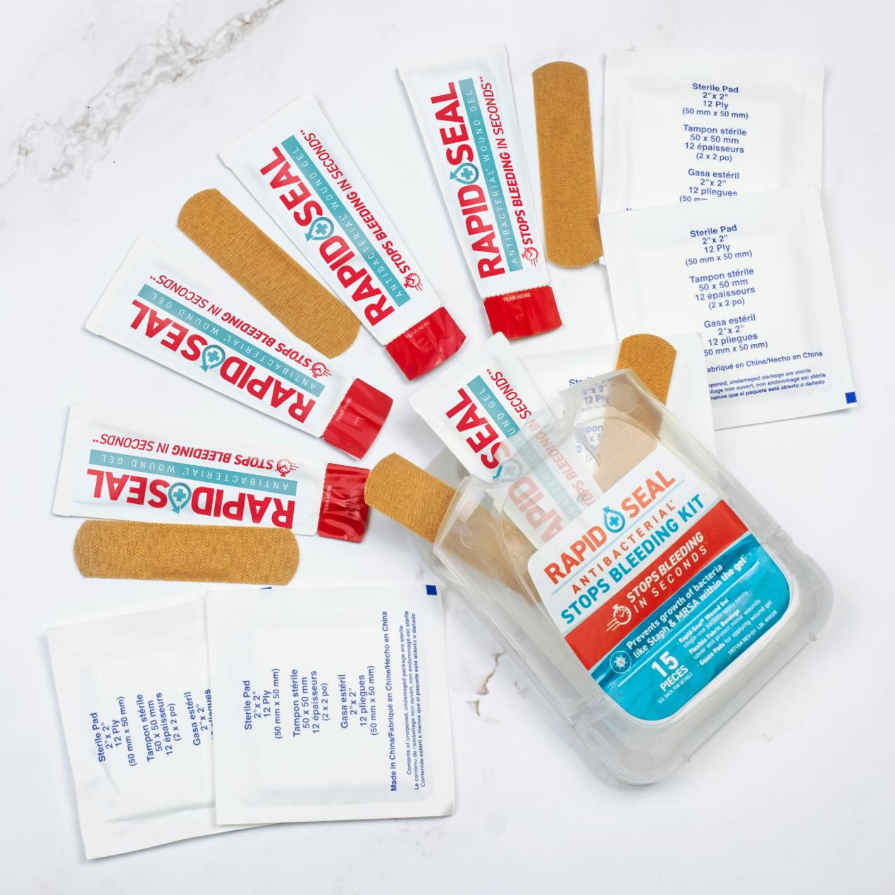 rapid seal kit with all of its contents coming out including bandages gauze pads and rapid seal single use packets
